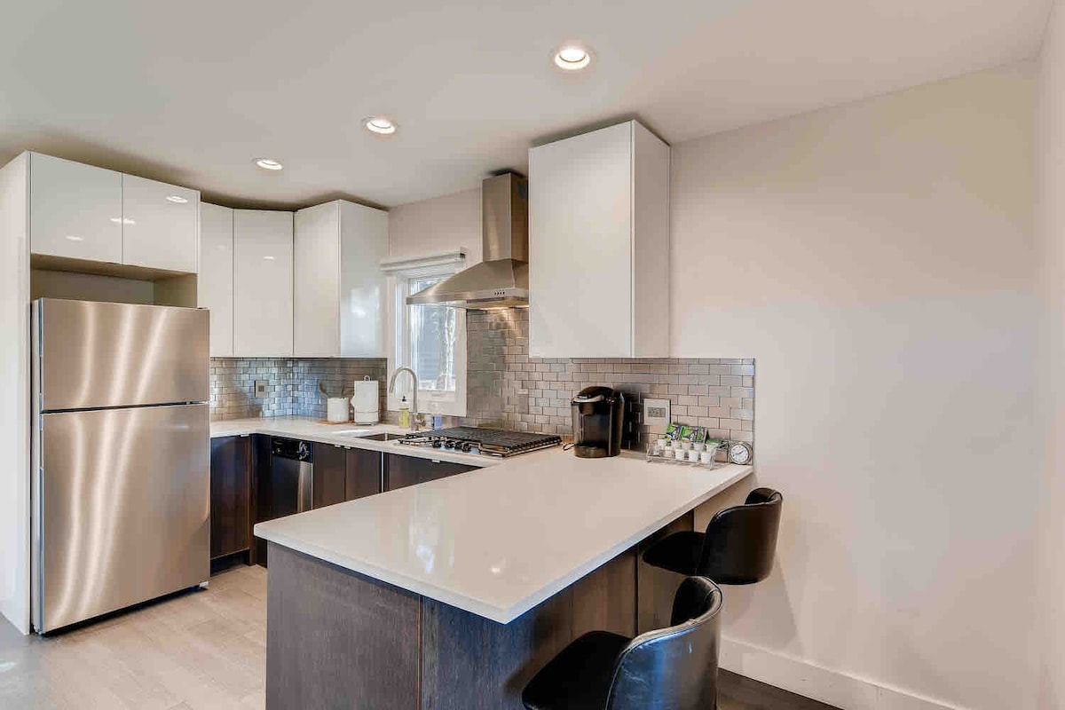The Cabin kitchen with quartz countertops, stainless steel appliances, and bar seating.