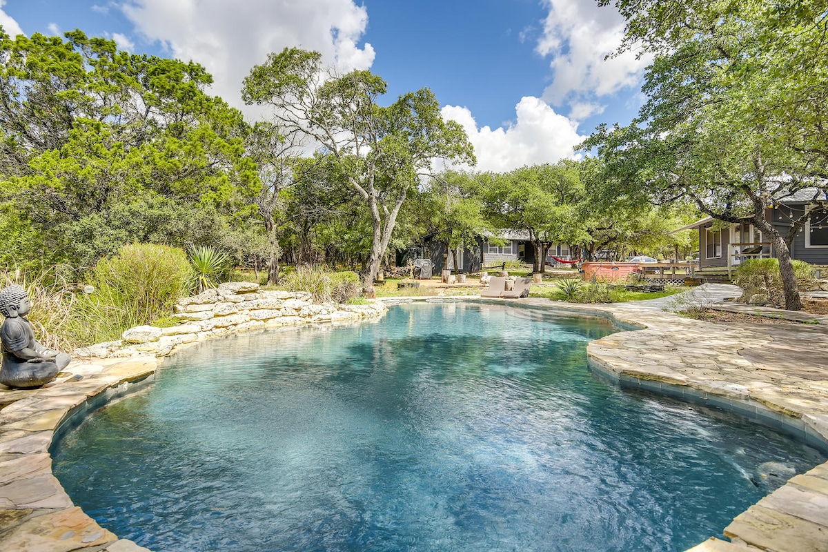 Natural stone swimming pool near The Cabin at Eco Valley with clear blue water, curved stone edges, lounge seating, and surrounding trees creating a tranquil outdoor retreat