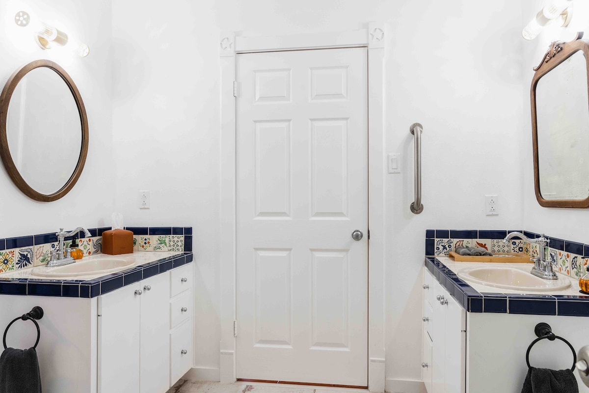 Casa Blanco bathroom with double vanity and blue tile countertops.