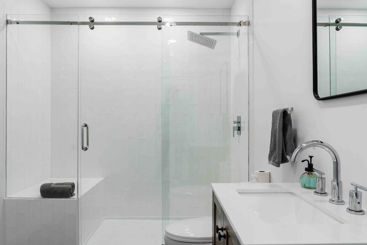 Casa Blanco modern bathroom with glass shower and white vanity.