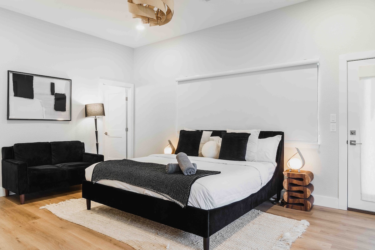 Bedroom in The Villa with modern king bed, soft lighting, and minimalist contemporary decor