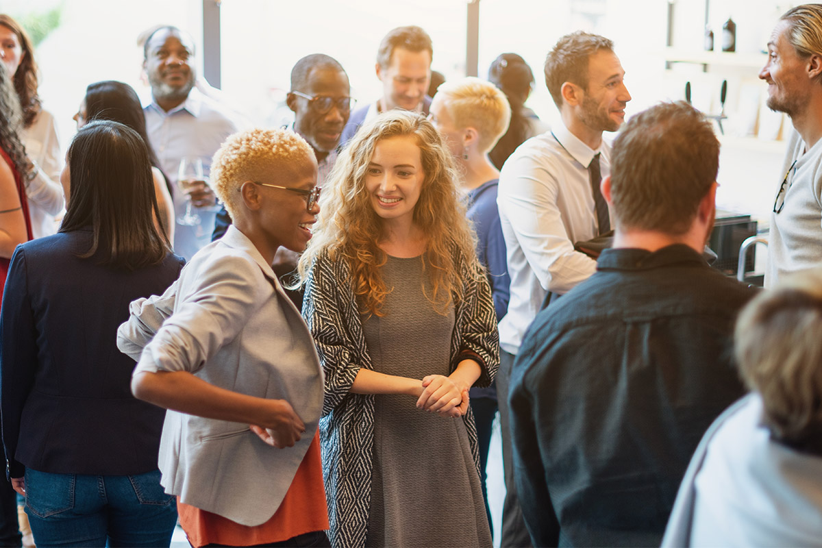 People conversing and connecting during a professional networking event.